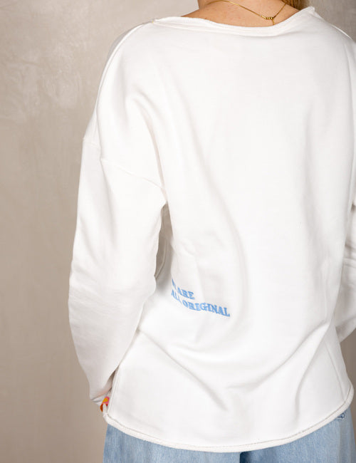 White sweater with smiley face and “Today I Have a Good Day” print